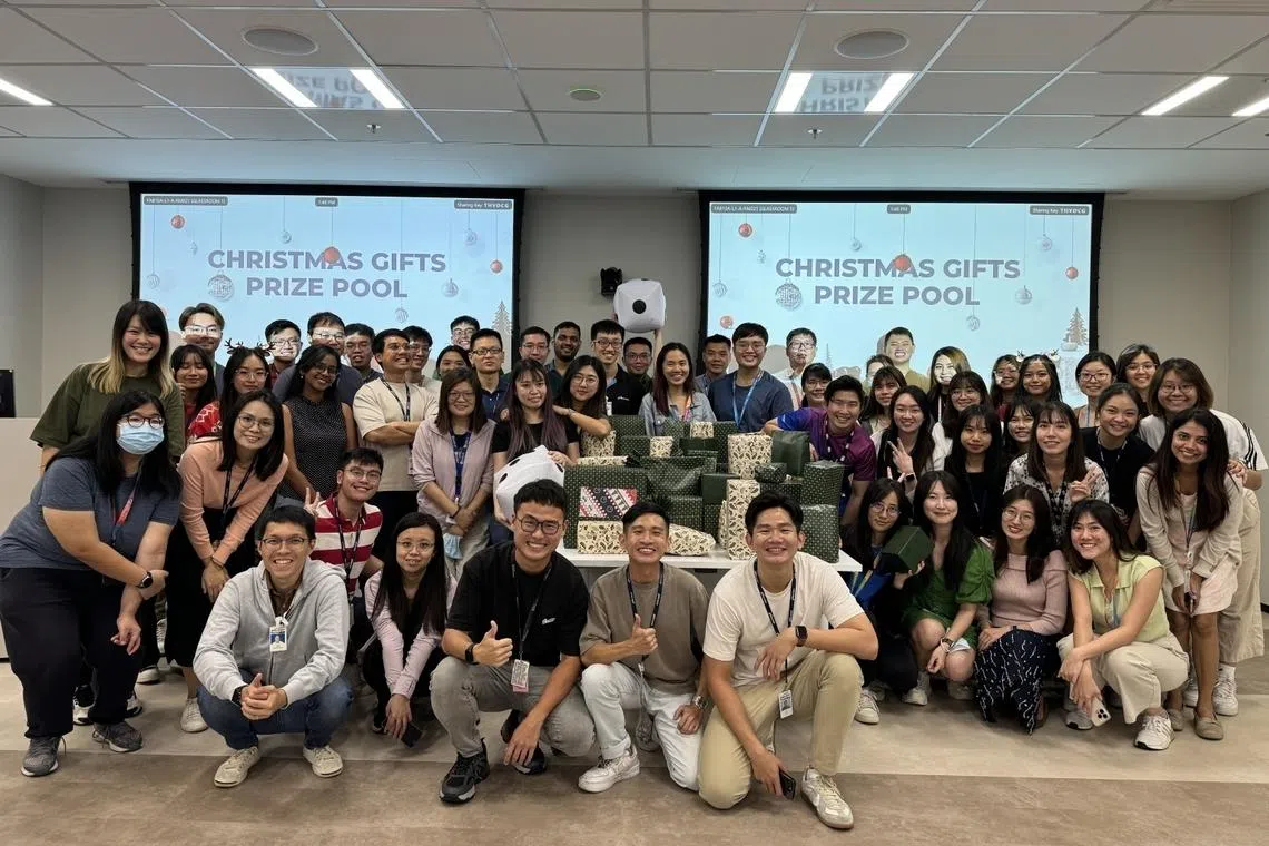 leroy lee (front row, second from right) from micron technology with department staff at a christmas gift-giving event in 2025 showing one of many occasions where employees bond beyond work, making the company one of the best places to work in singapore