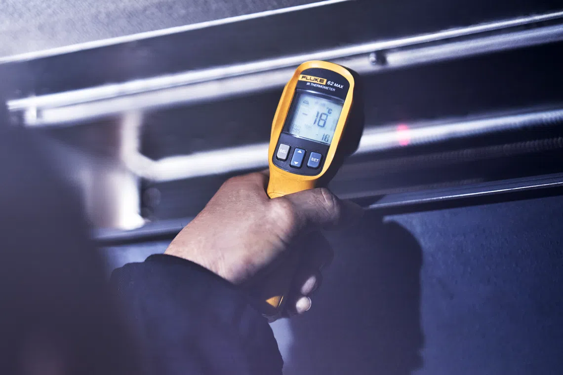 A staff member checks that temperatures hold at minus 18 deg C in delivery trucks at Jurong Cold Store.