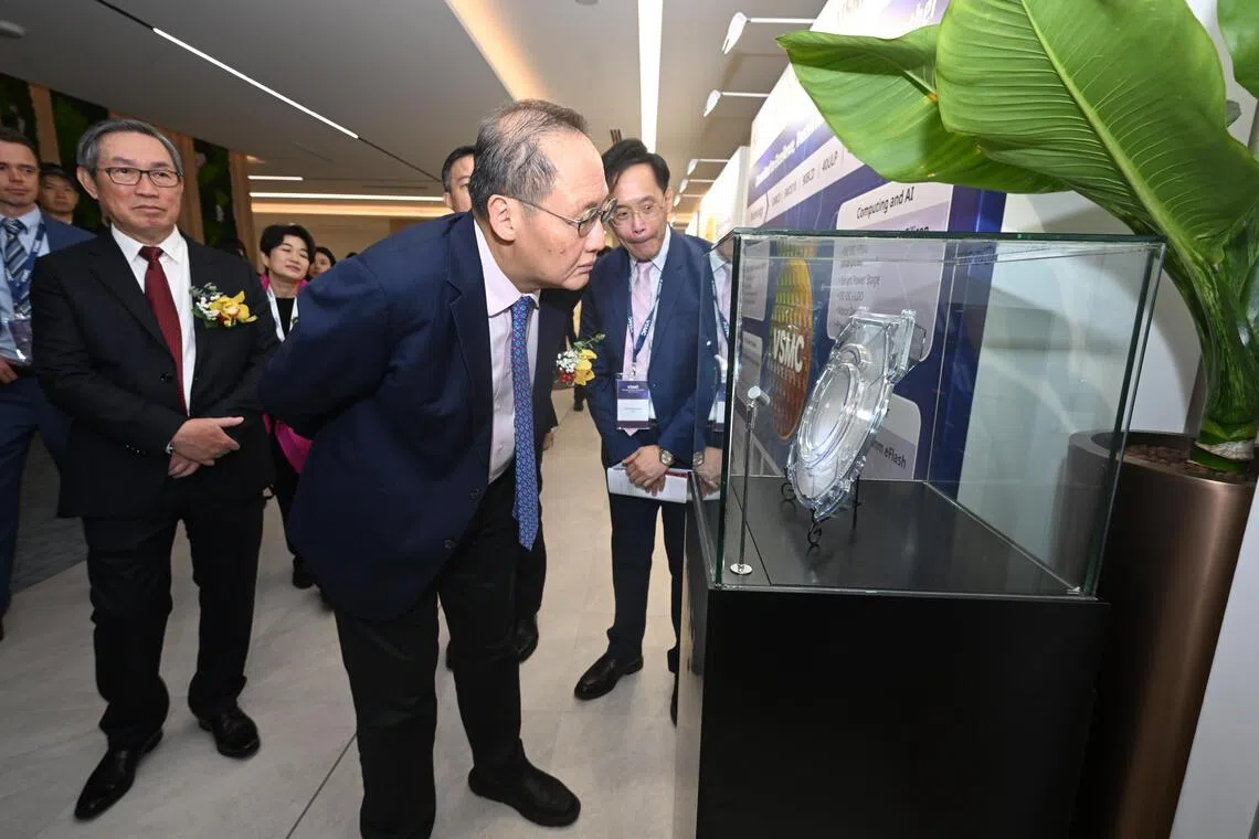 Minister for Trade and Industry (Energy and Industry) Tan See Leng viewing a display of a wafer fab during the opening ceremony of VisionPower Semiconductor Manufacturing Company on Sept 28.