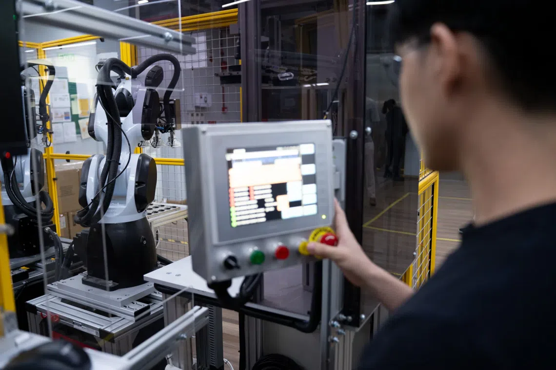 A Sunningdale Tech employee operating the AI-powered vision system.